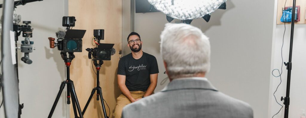 Storyteller Studios Producer Chris Costello laughs with an interview subject during an on-camera interview