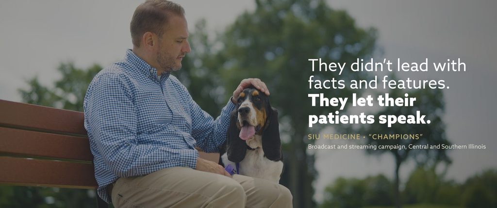 A frame from SIU Medicine’s “Champions” campaign: Rich sits on a park bench with his basset hound. Text over image: “They didn’t lead with facts and features. They let their patients speak.”