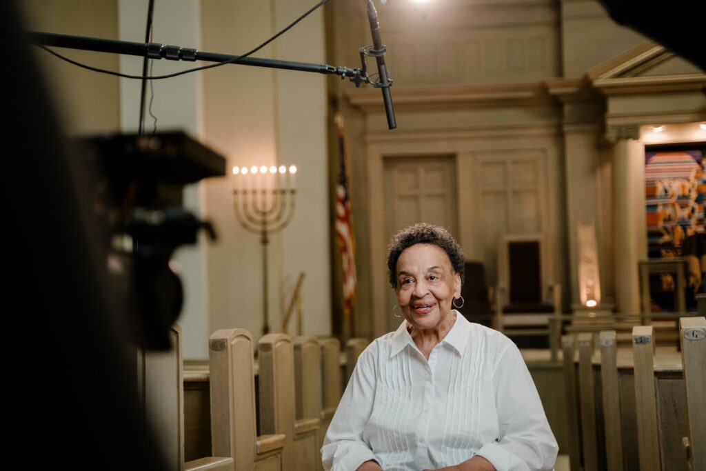 Behind the scenes of a Storyteller Studios video interview with a nonprofit subject, filmed in a historic church.