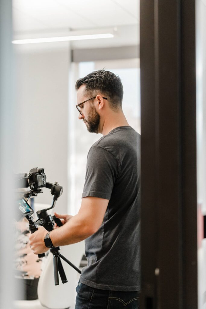 A Storyteller Studios crew member adjusting a gimbal-mounted camera during a corporate shoot on location.