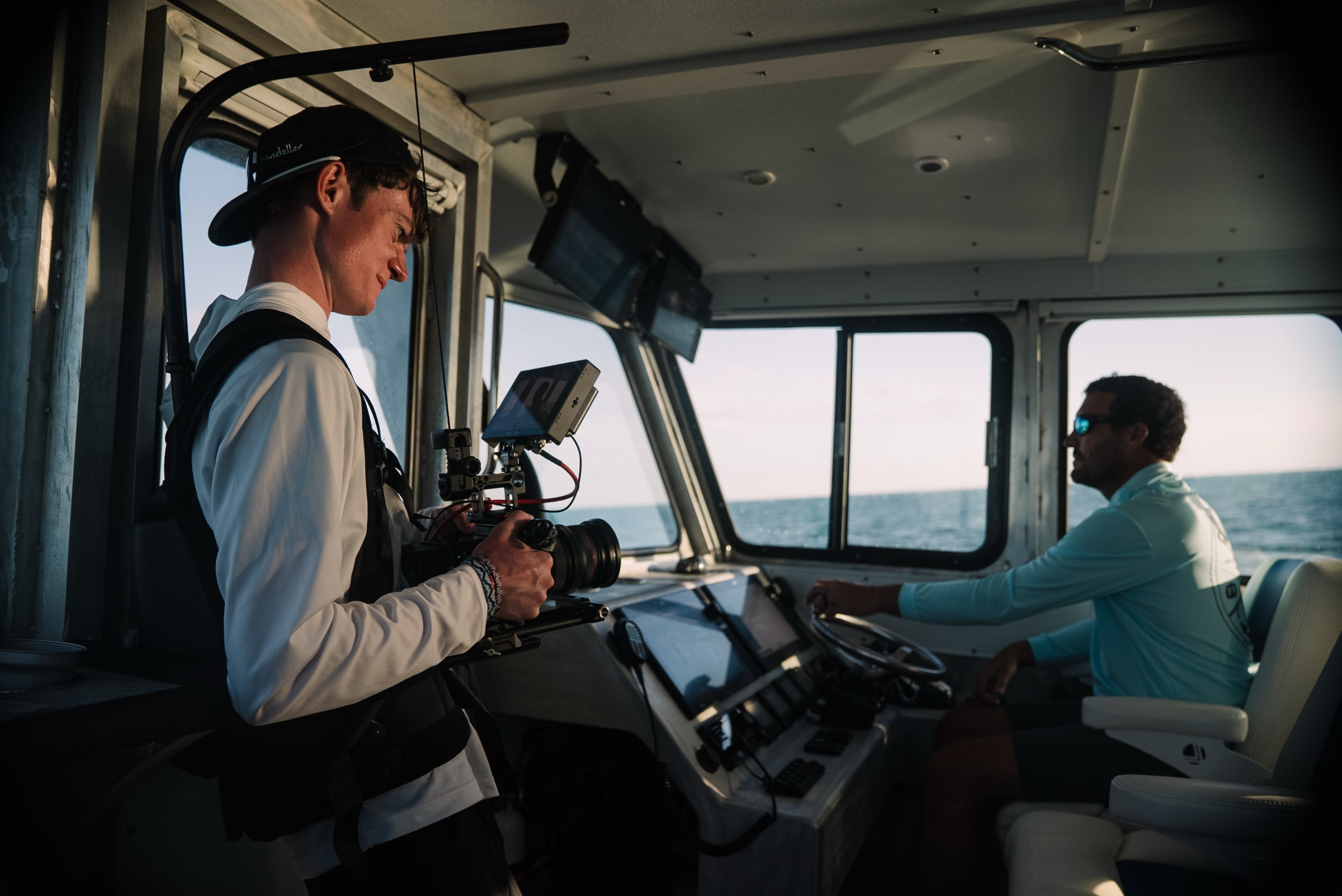 Cinematographer Eli Ommen films charter captain Robert Trosset at the helm of his catamaran during Dometic Marine's customer story shoot.
