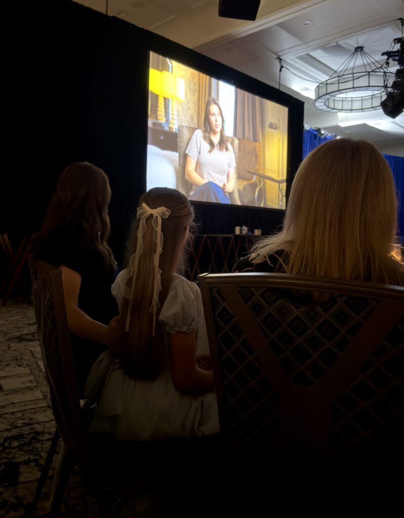 The Darch family watches their story on the big screen at the National Children's Cancer Society annual gala.